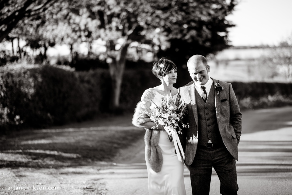 a photo of a bride and groom in a country lane
