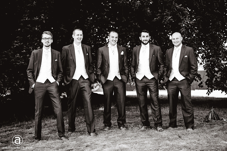 A black and white photo of a group of groomsmen at a wedding at Kenwick Park.