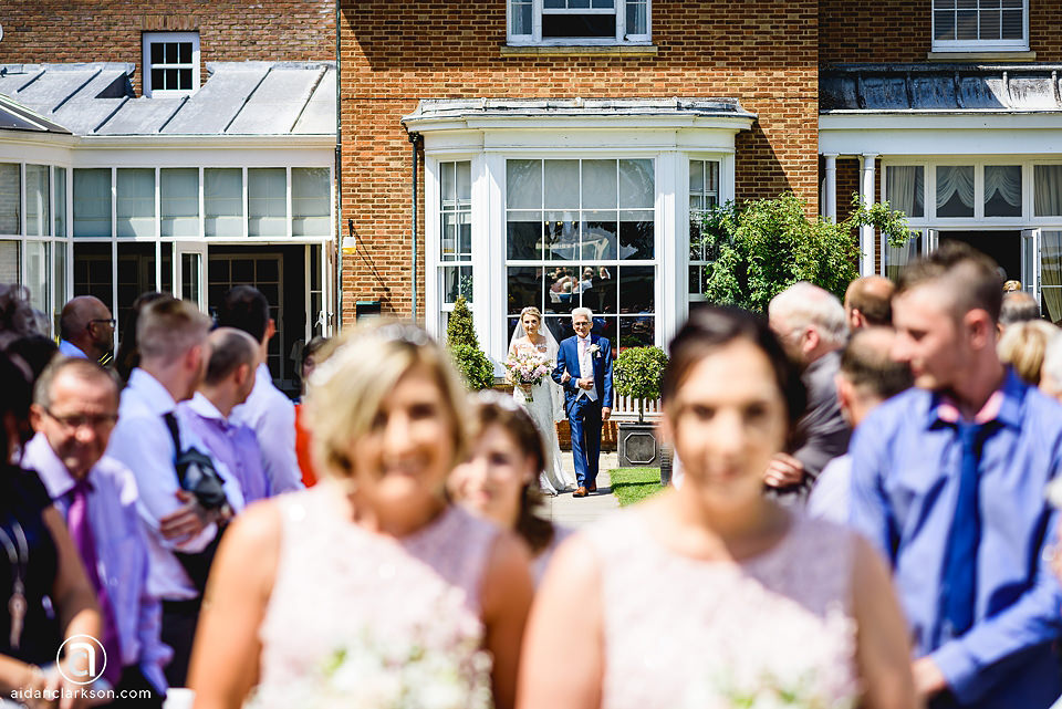 A bride and groom walking down the aisle at a wedding ceremony held at Kenwick Park.