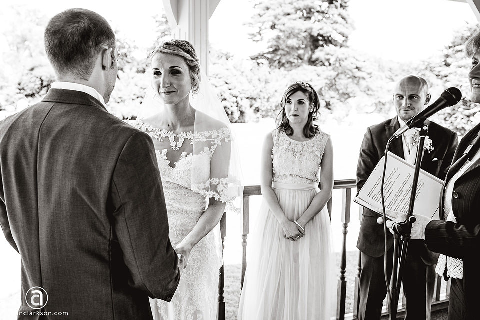 A black and white photo capturing a wedding ceremony at Kenwick Park.