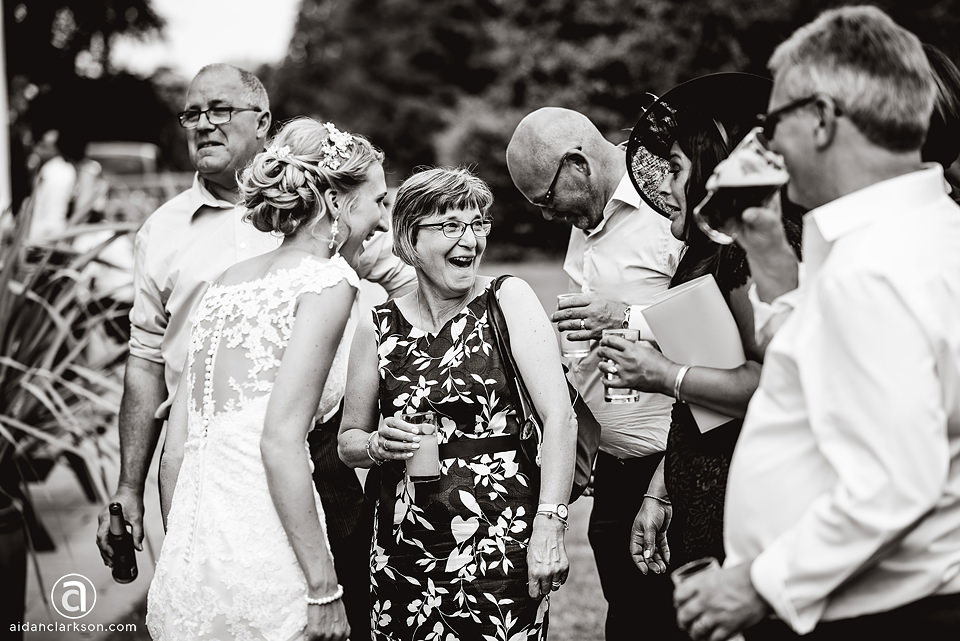 A black and white photo of a group of people at a wedding at Kenwick Park.