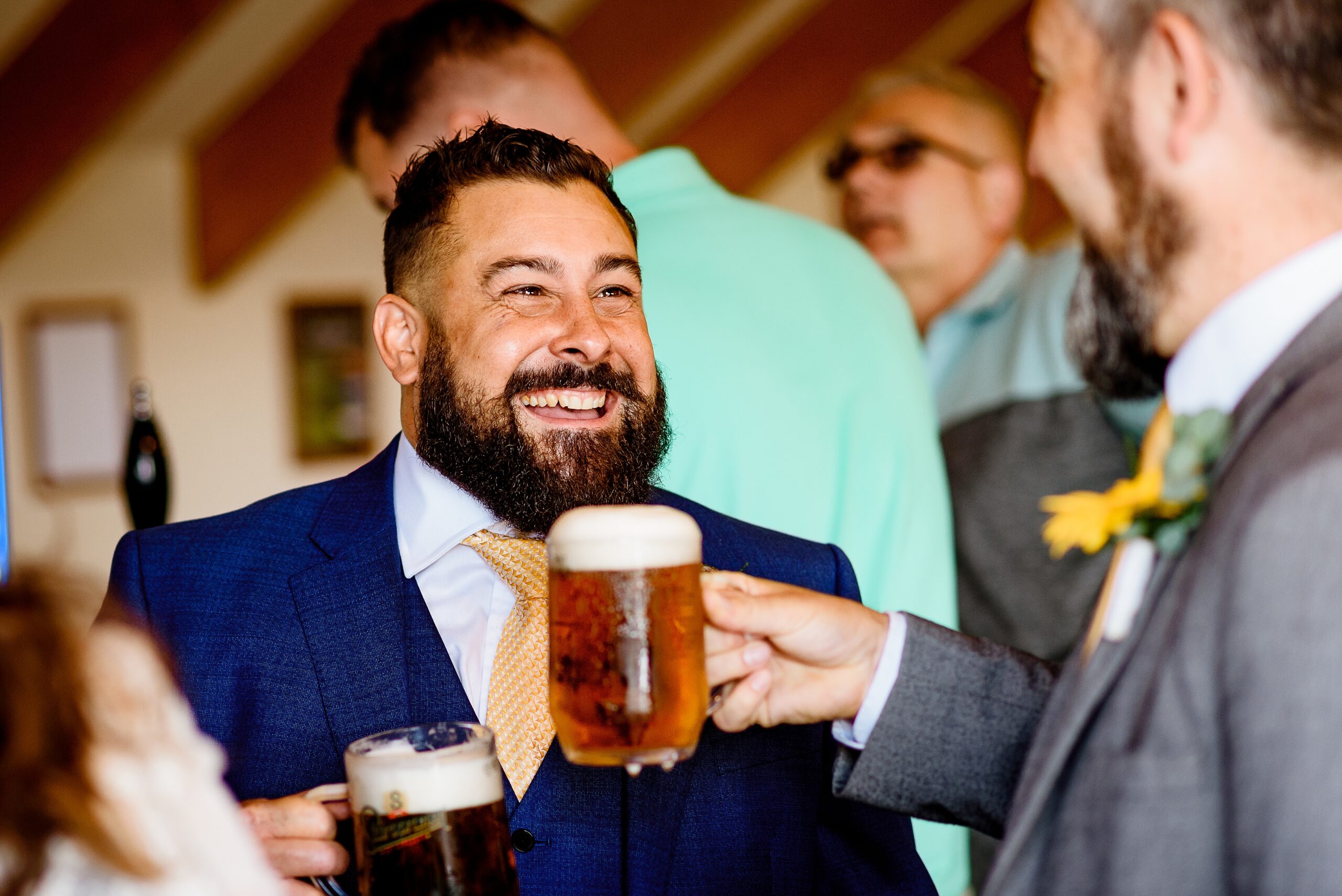 the groom with a pint at his boston wedding
