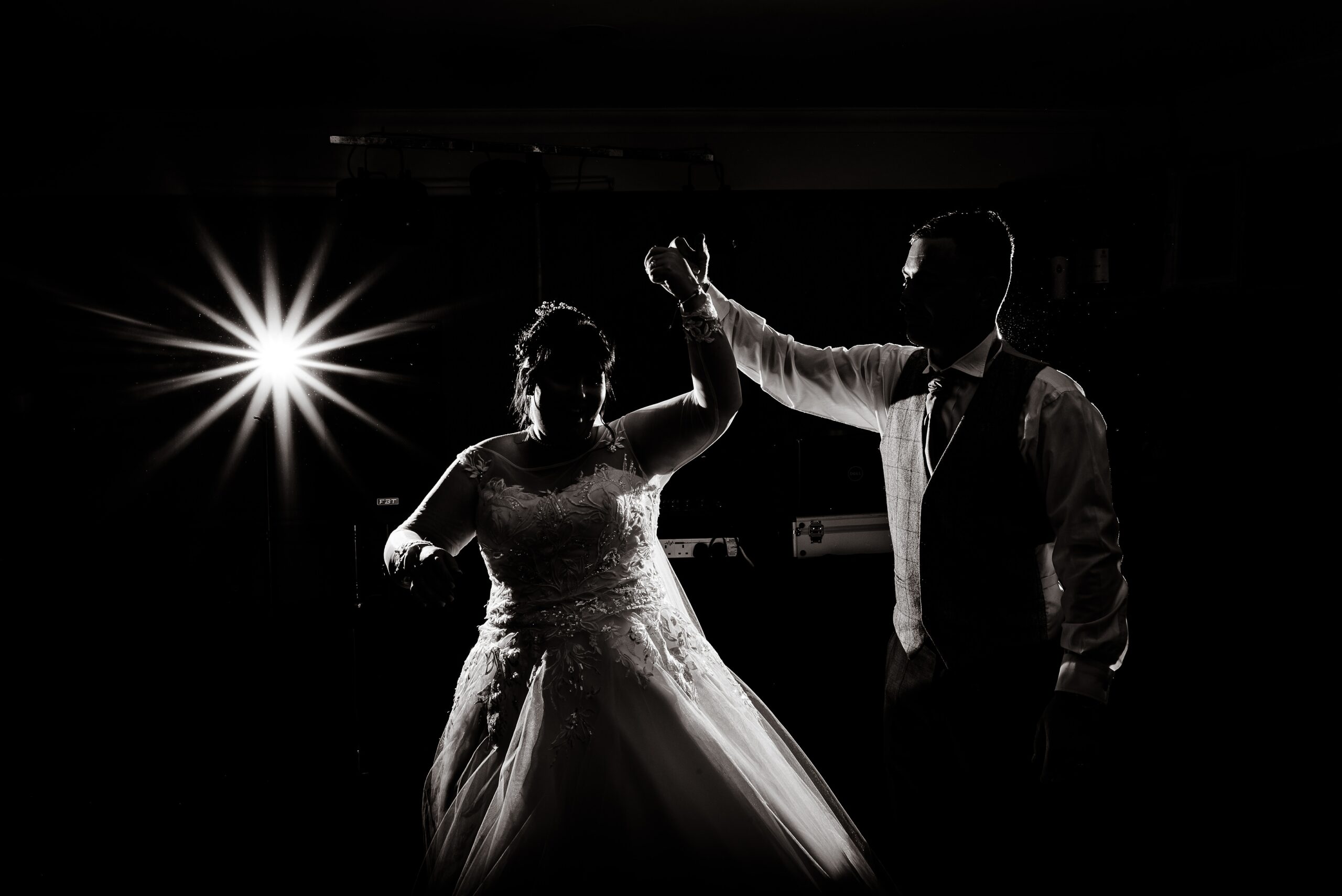 A mesmerizing scene unfolds at Laceby Manor, as a radiant bride and her dashing groom gracefully sway together in an enchanting dance, illuminated by the soft glow of candlelight.