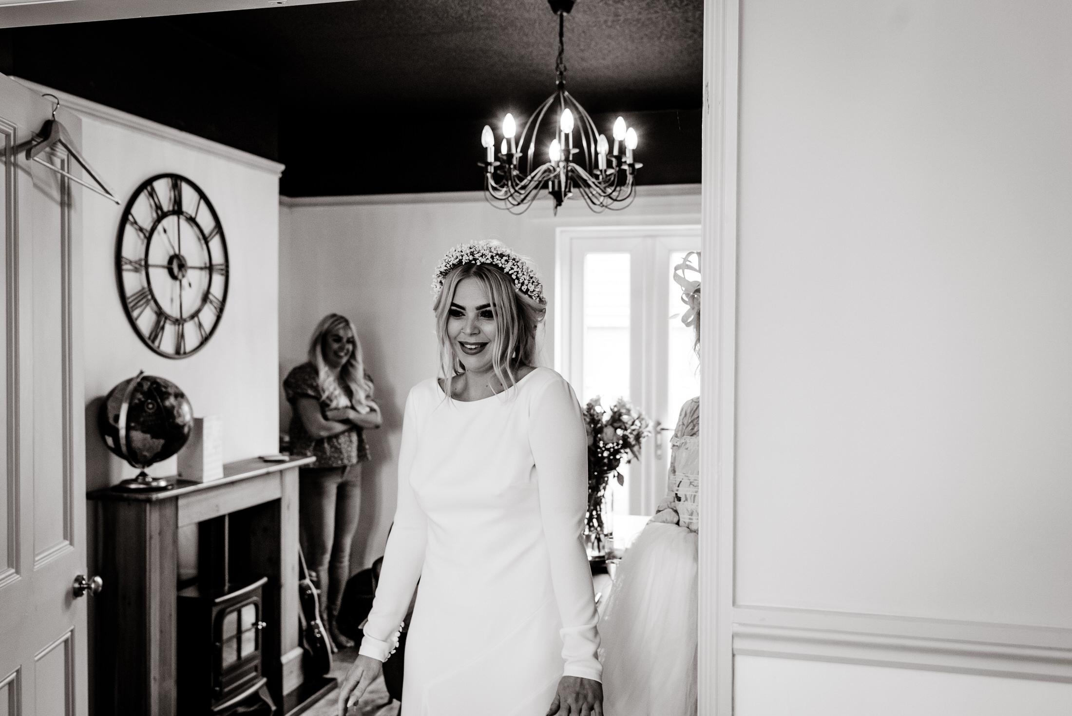 A wedding bride in a white dress standing in a doorway at the Scrivelsby Walled Garden.
