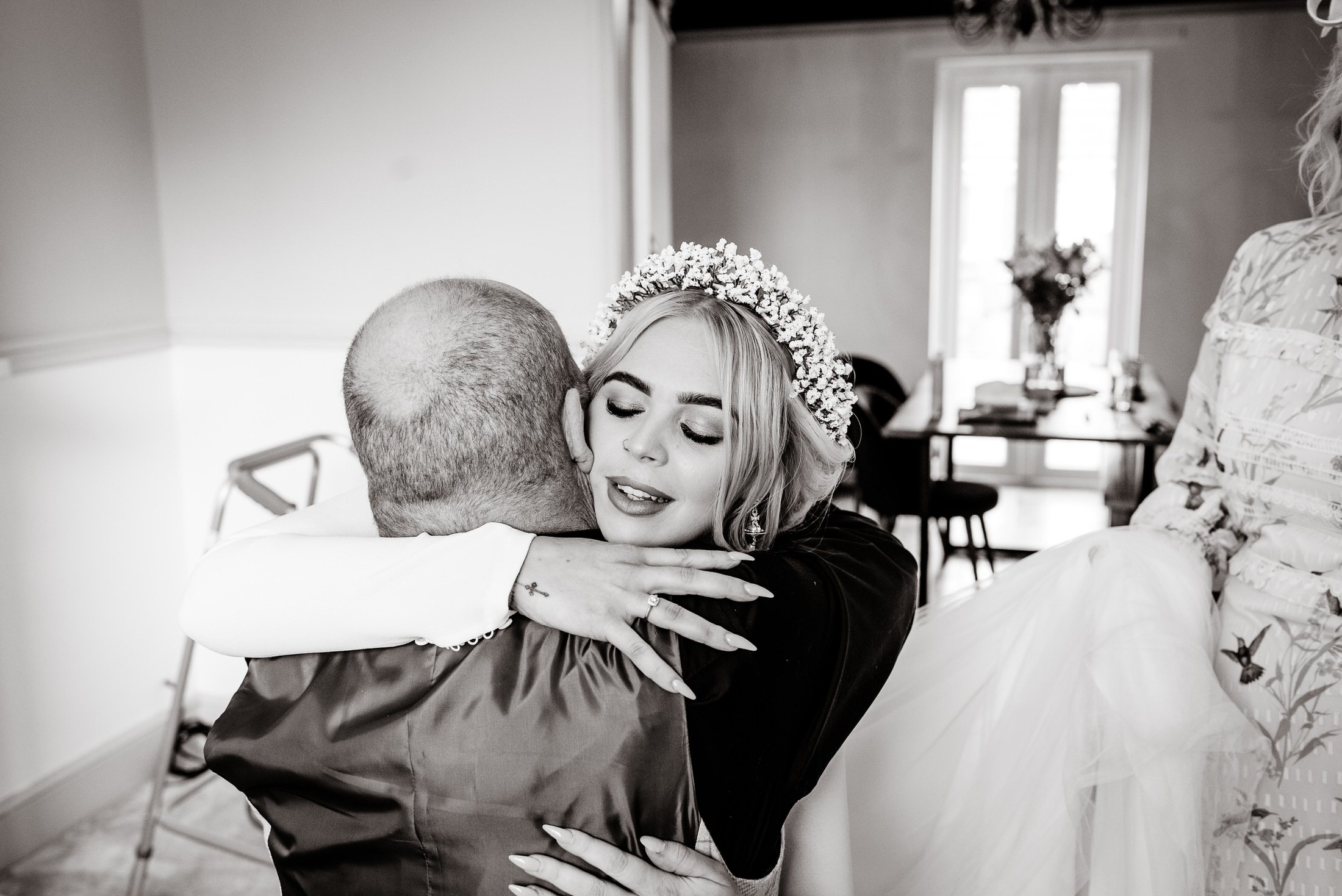 A bride is hugging her father as she gets ready for her wedding at Scrivelsby Walled Garden.