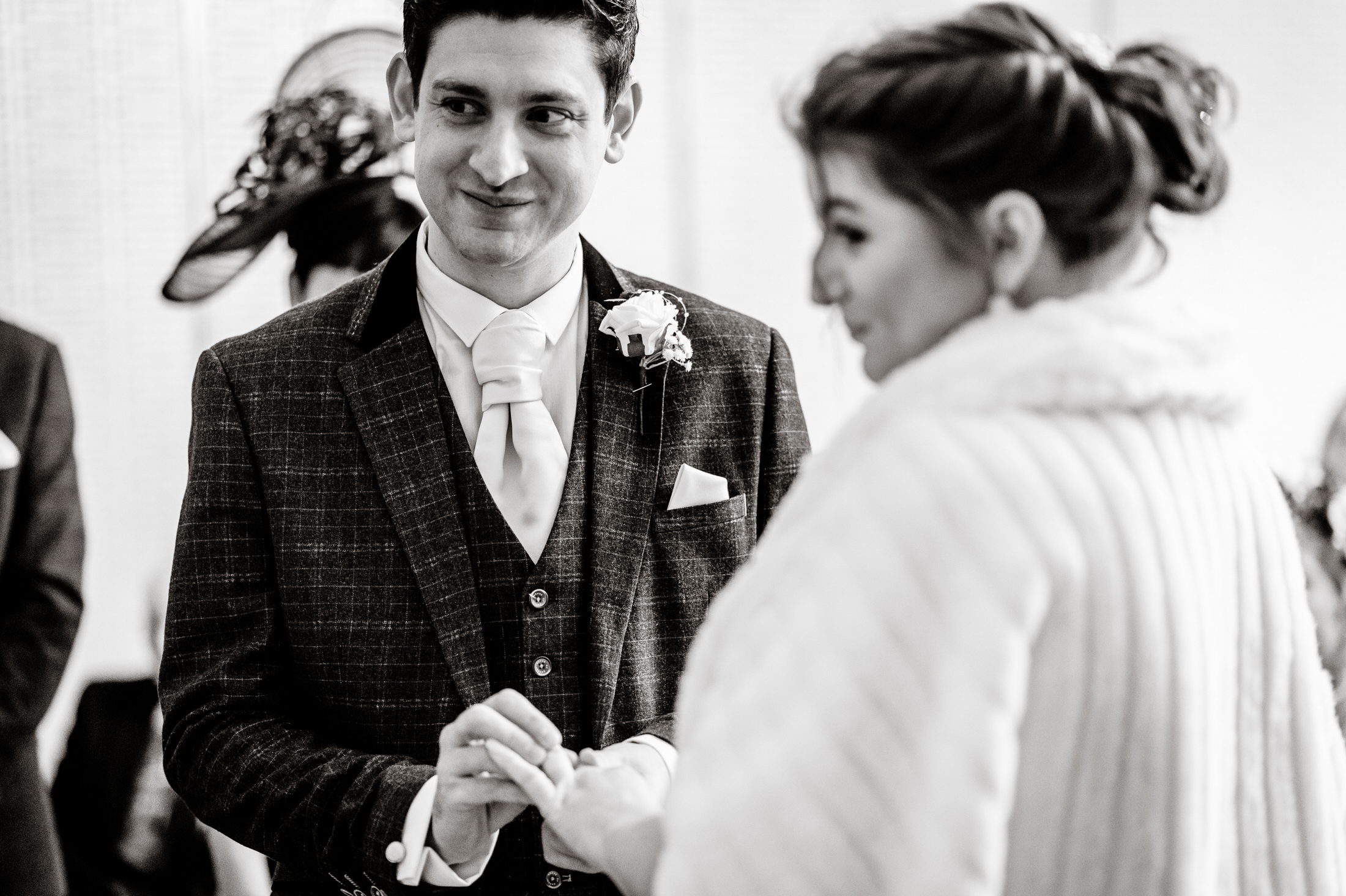 A bride and groom exchange rings during their Brackenborough Hotel wedding ceremony.