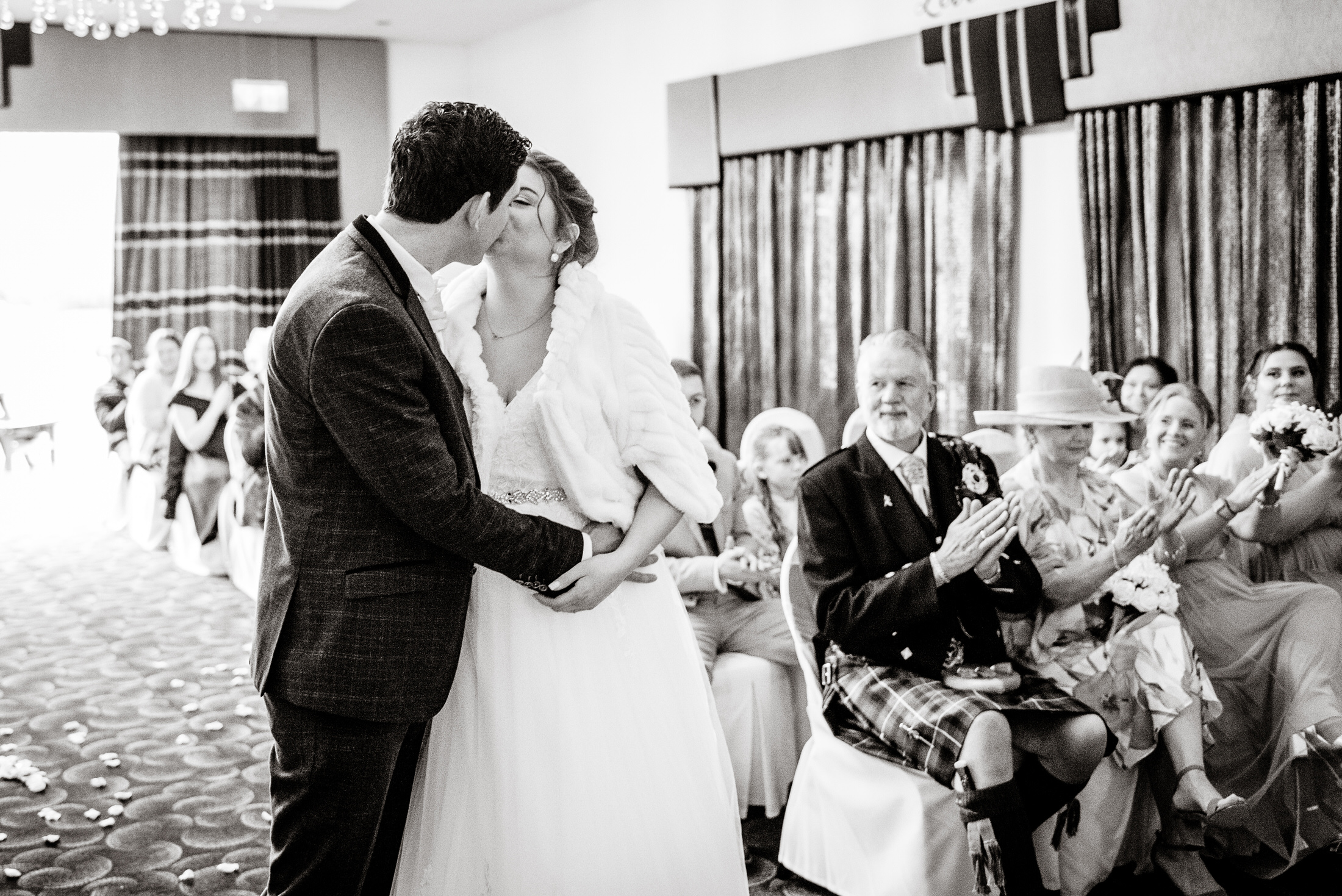 A bride and groom share a tender kiss during their wedding ceremony at Brackenborough Hotel.