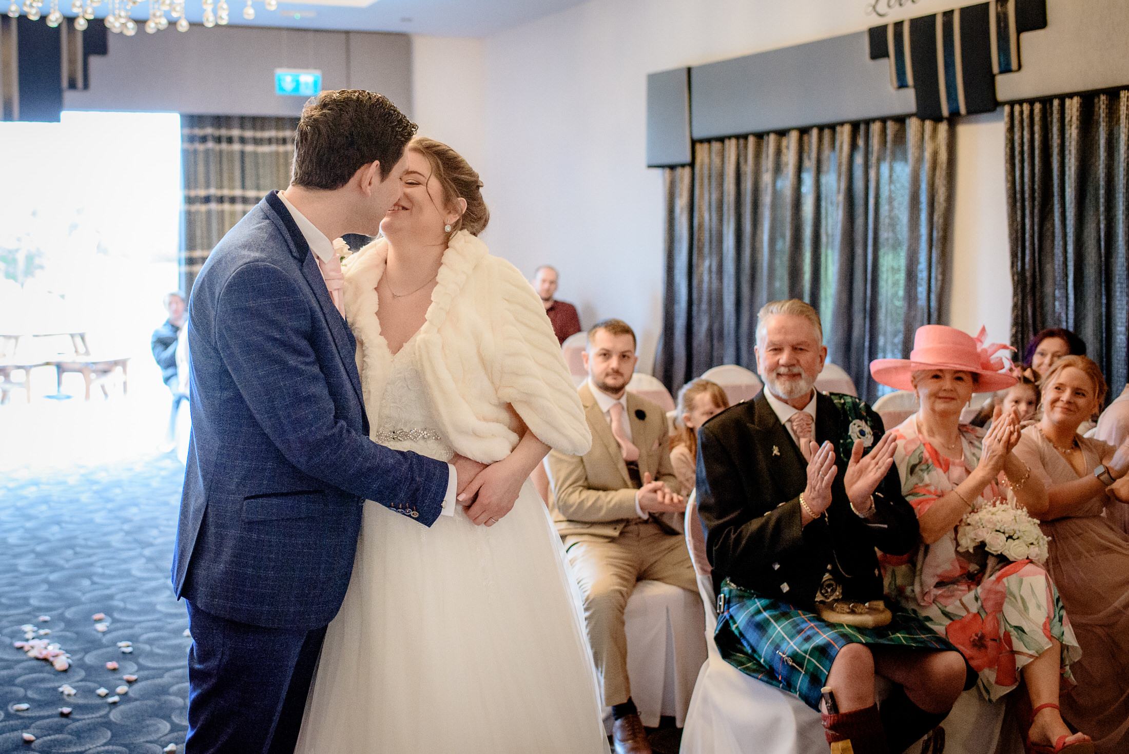 A bride and groom kiss during their Brackenborough Hotel wedding ceremony.