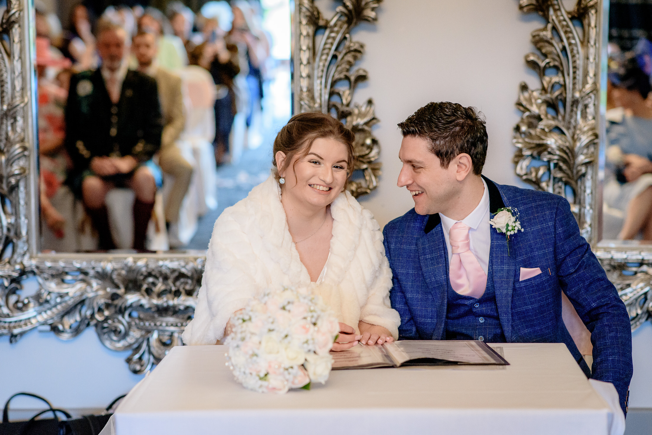 A bride and groom signing their wedding vows at the Brackenborough Hotel.