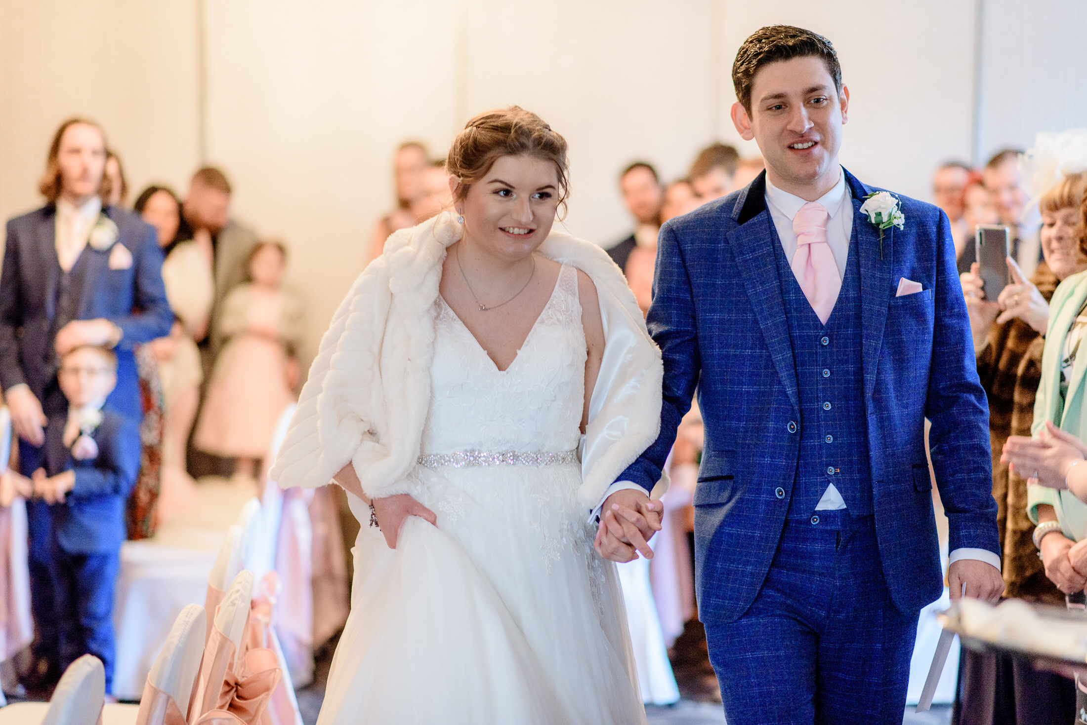 A bride and groom walking down the aisle at their Brackenborough Hotel wedding.