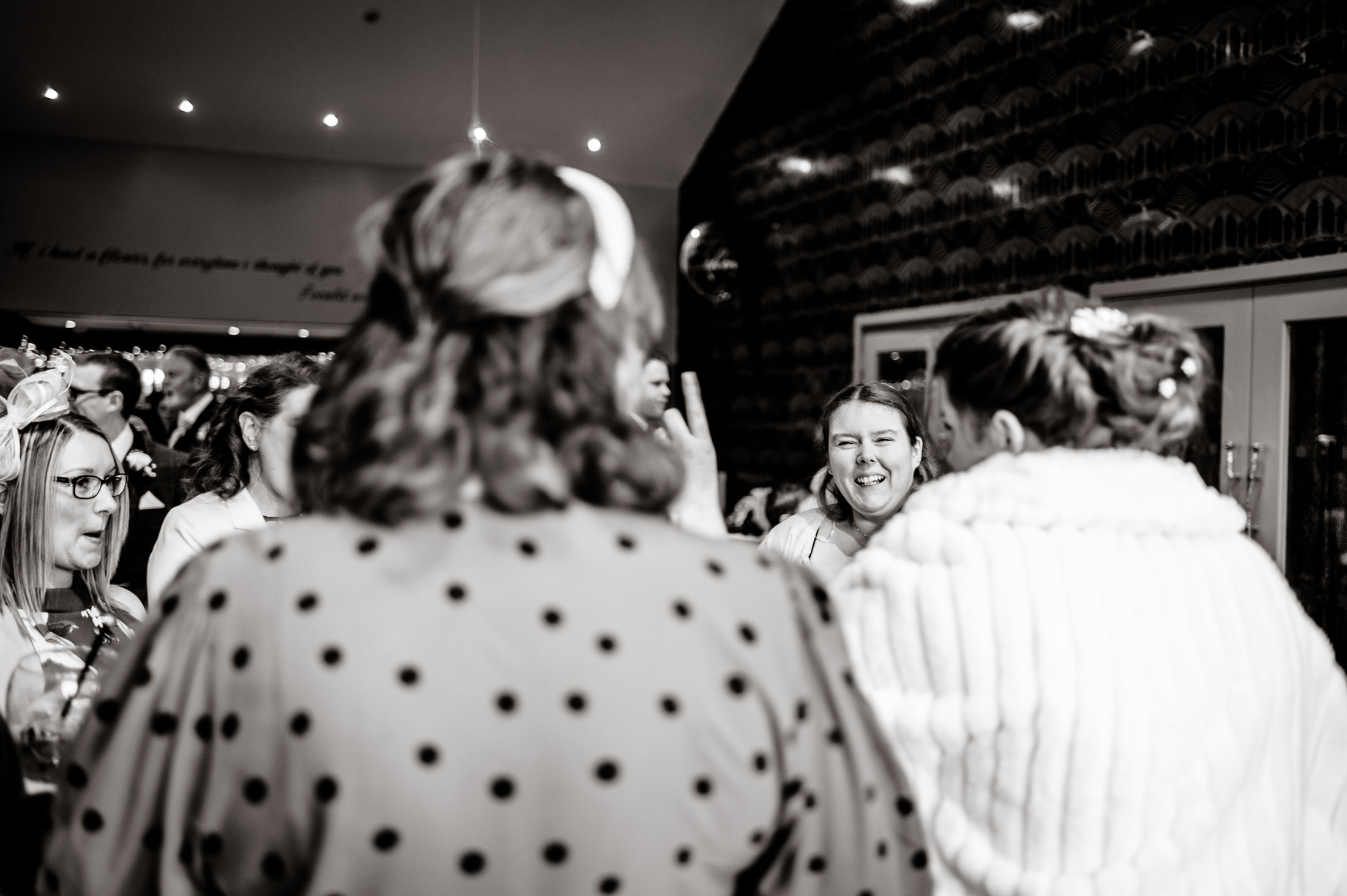 A black and white photo taken at a wedding party held at the Brackenborough Hotel, featuring a group of people.