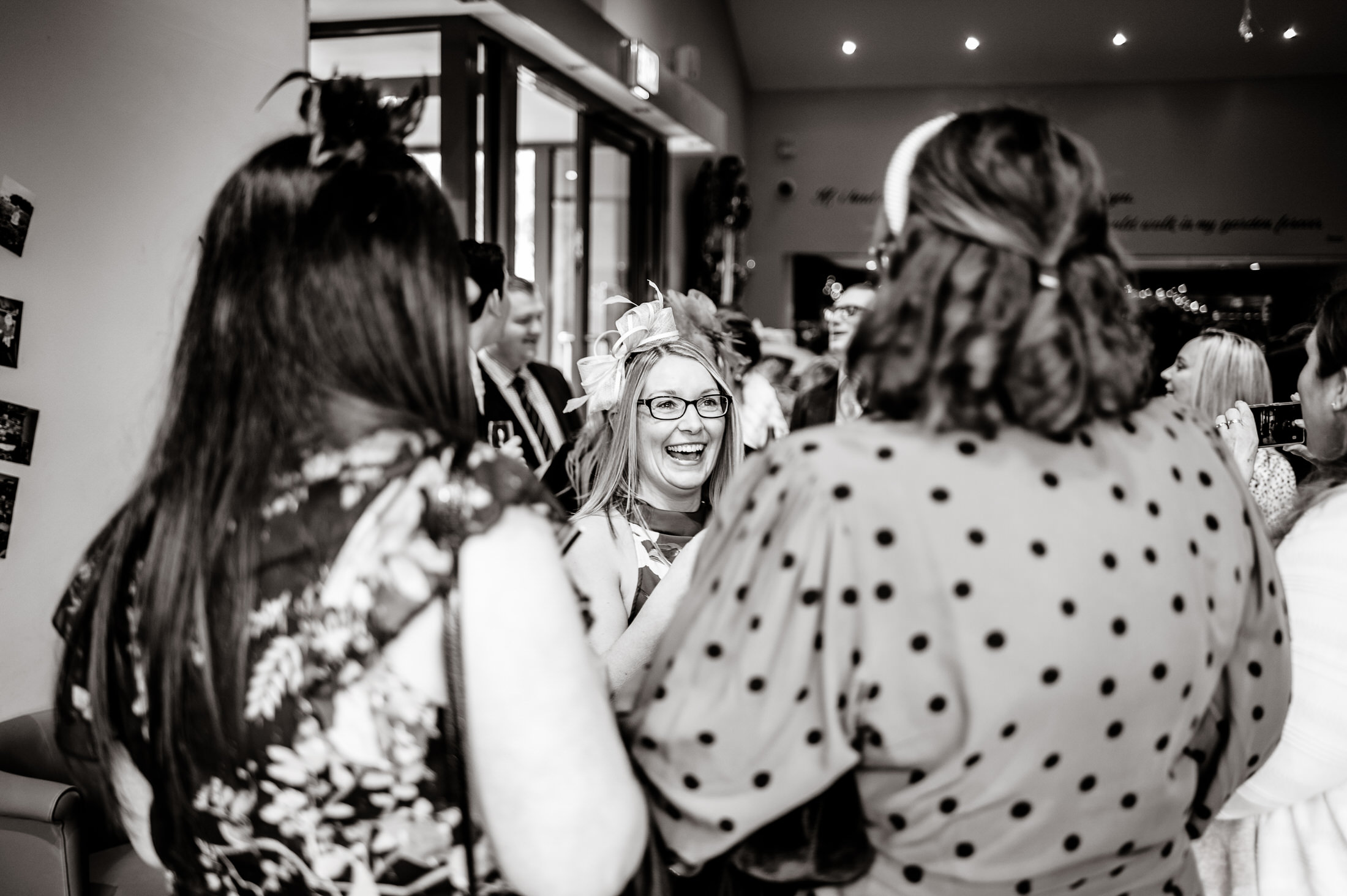 A black and white photo of a group of people at Brackenborough Hotel wedding.