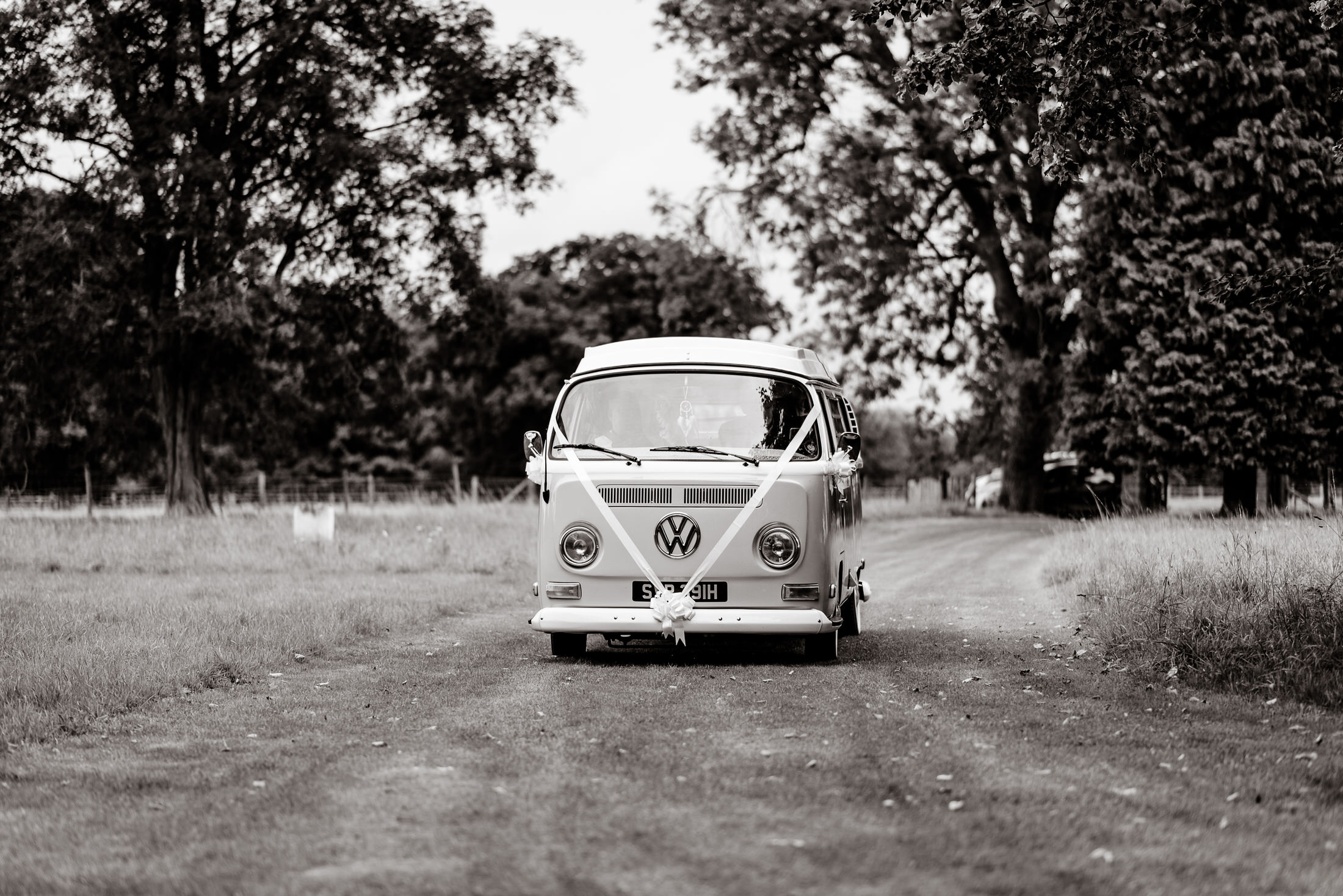 A black and white photo of a vw bus on a dirt road near Scrivelsby Walled Garden.