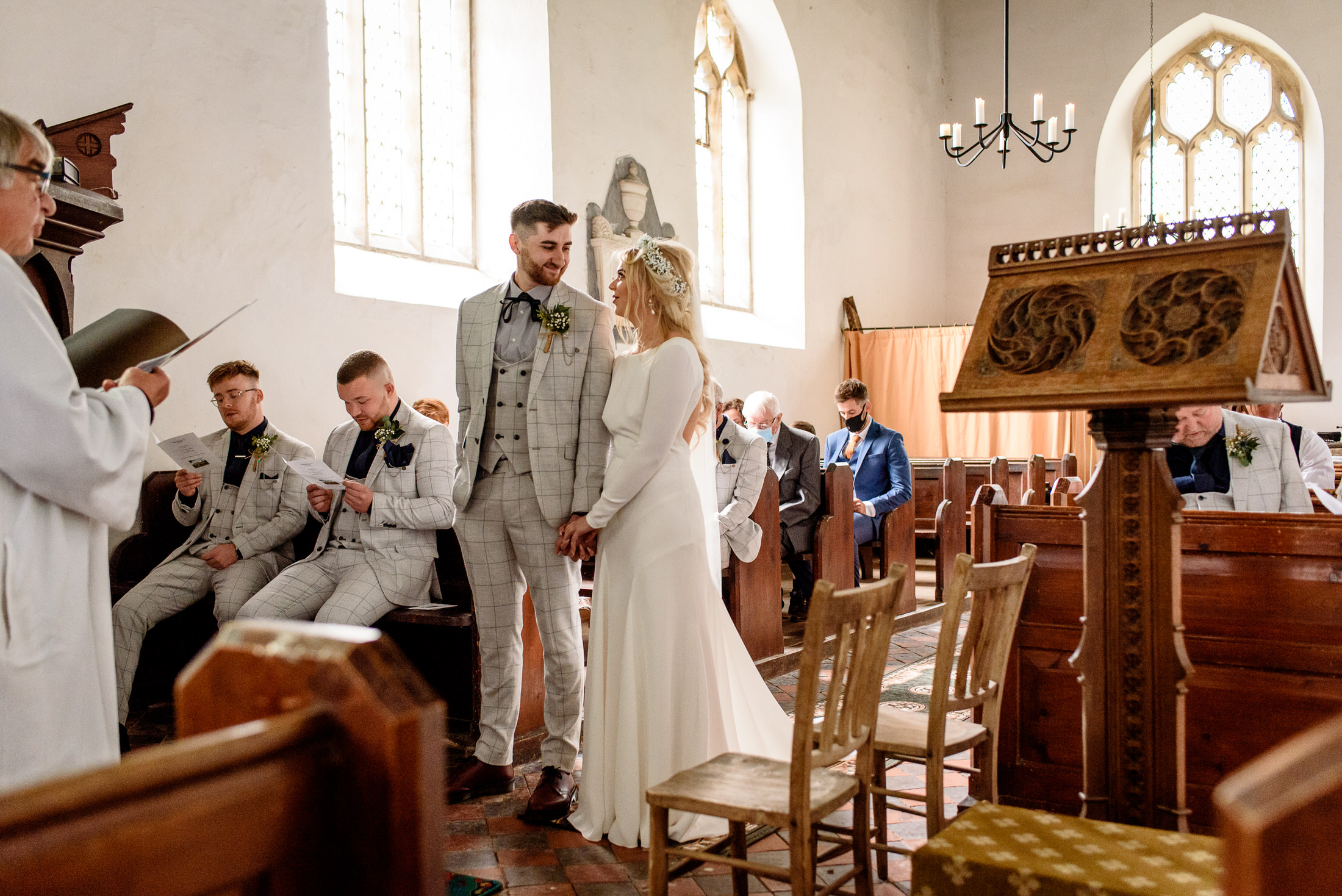 A bride and groom celebrating their wedding in a church surrounded by the lush beauty of the Scrivelsby Walled Garden.