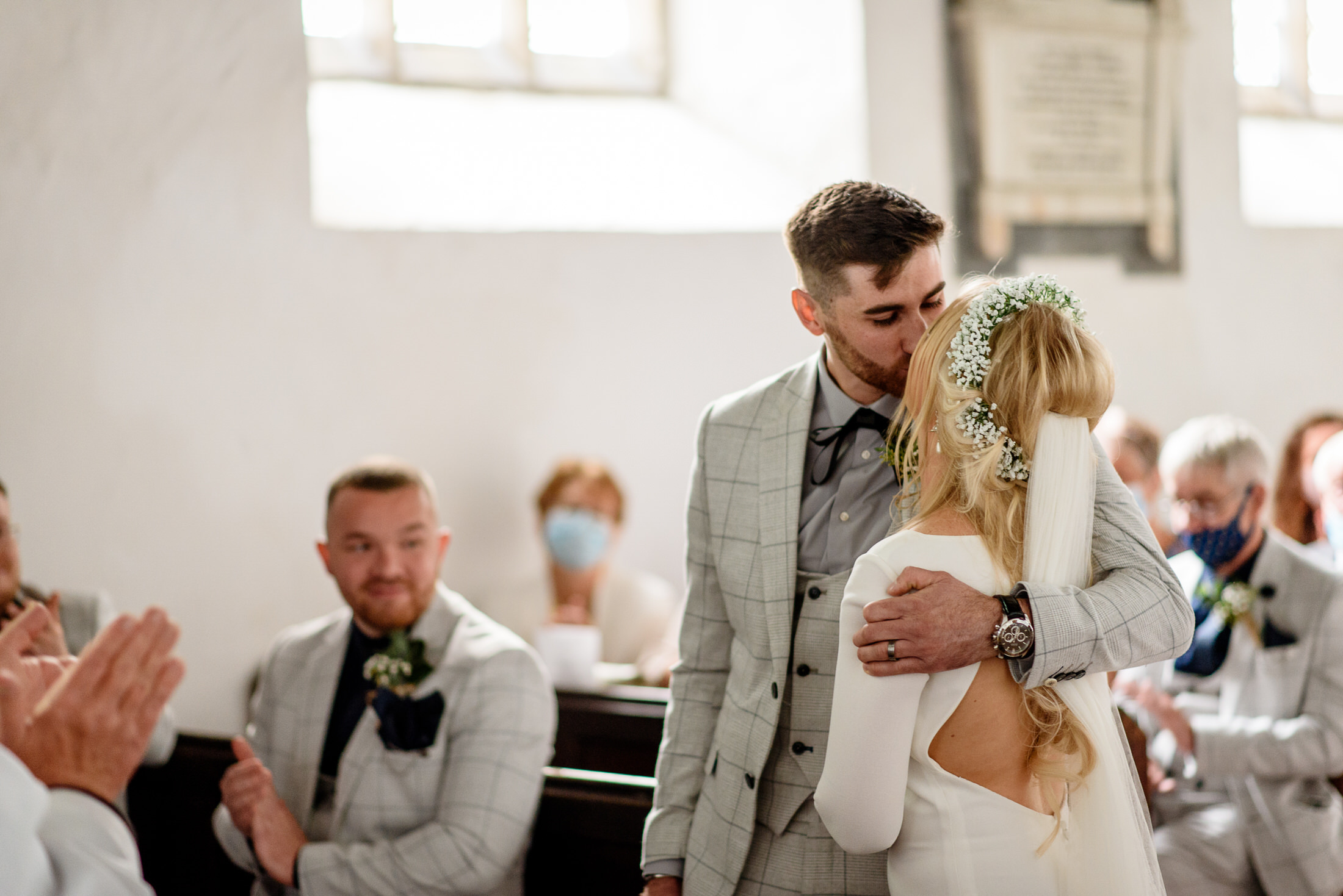 A bride and groom kiss during their Scrivelsby Walled Garden wedding ceremony.