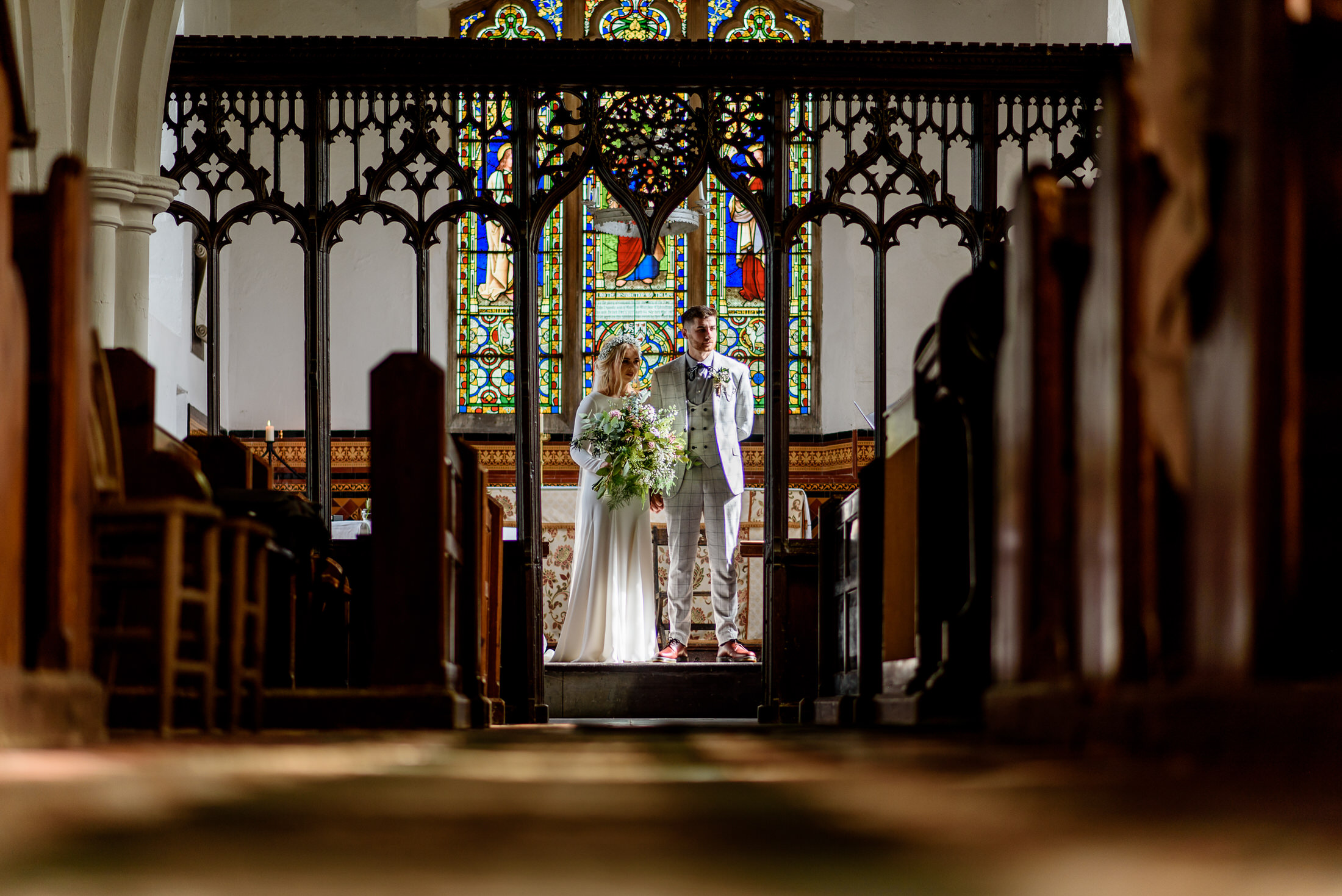 A wedding couple standing in Scrivelsby Walled Garden.