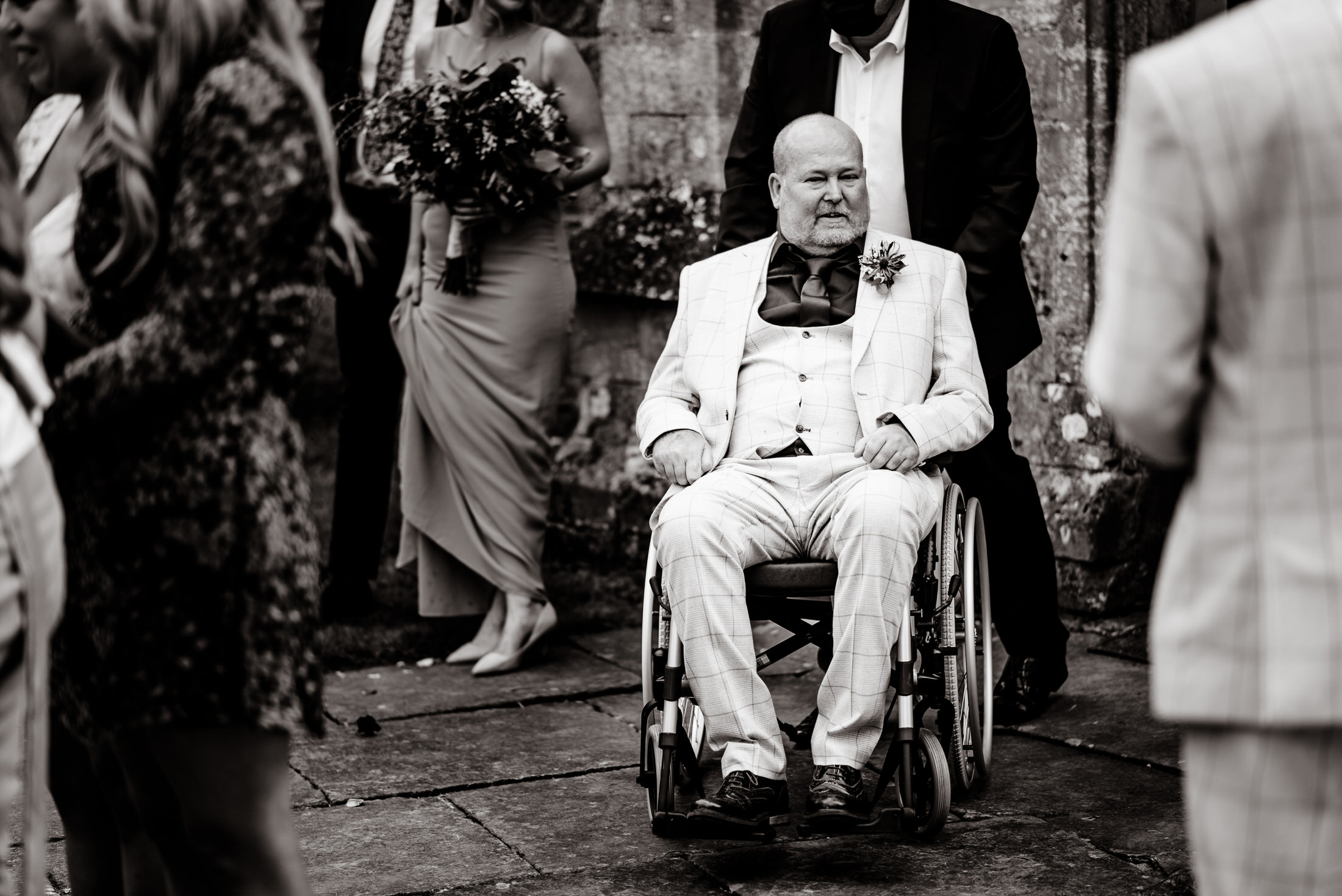 A man in a wheelchair attending a wedding at Scrivelsby Walled Garden.