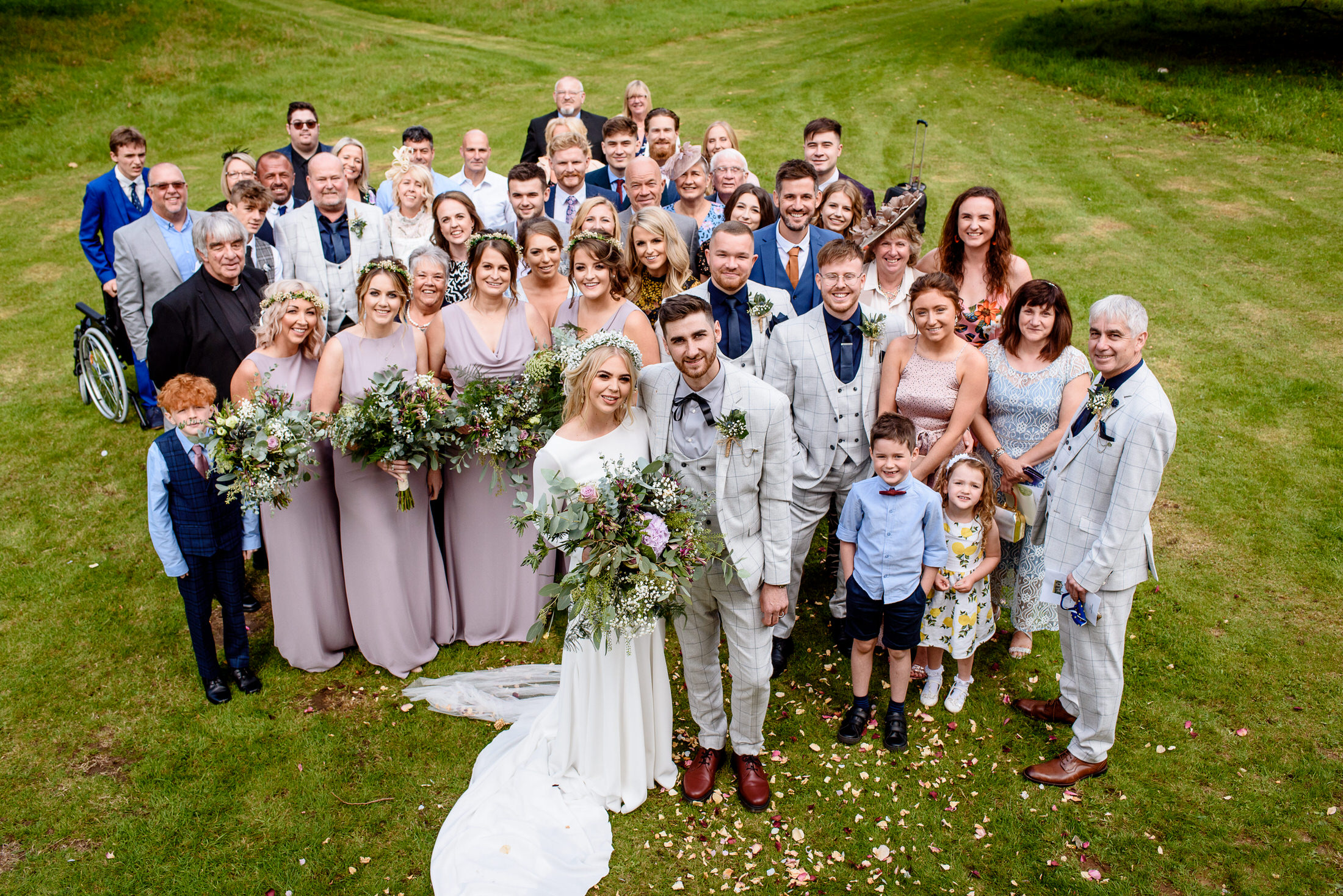 A wedding party posing for a photo in the enchanting Scrivelsby Walled Garden.