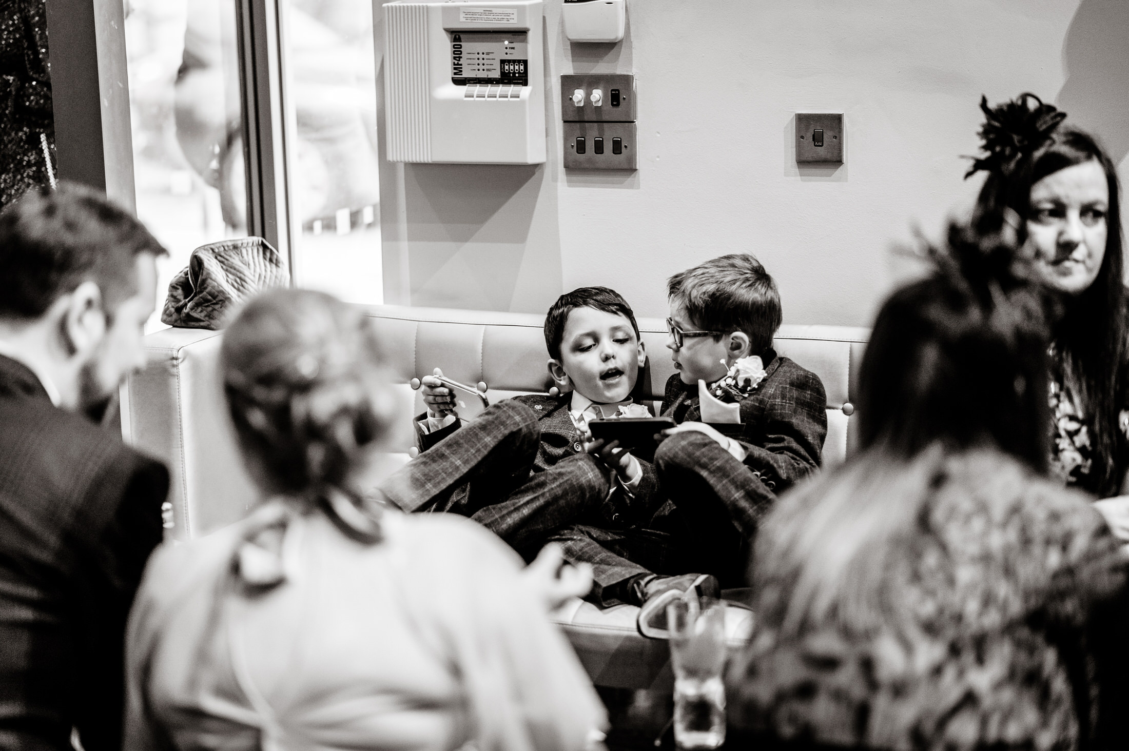 A group of kids sitting on a couch at the Brackenborough Hotel wedding.