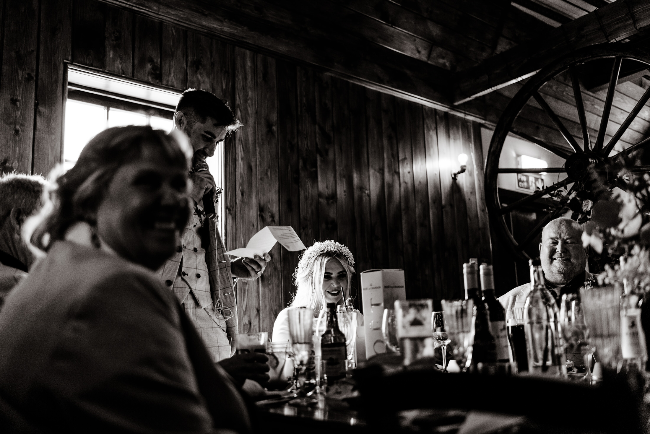 A black and white photo of a group of people sitting at a table in the scrivelsby walled garden.