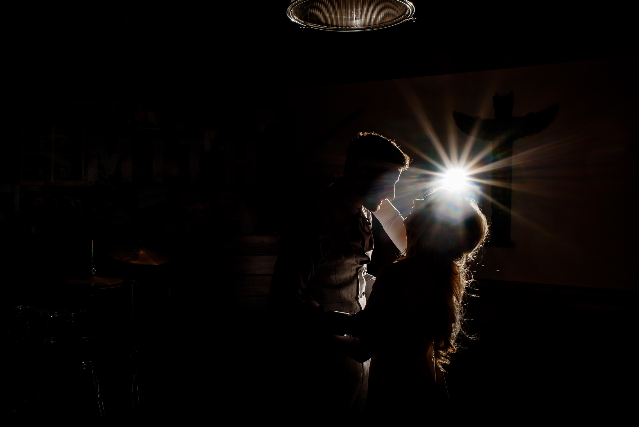 A wedding couple standing in the dark with a light shining on them at Scrivelsby Walled Garden.