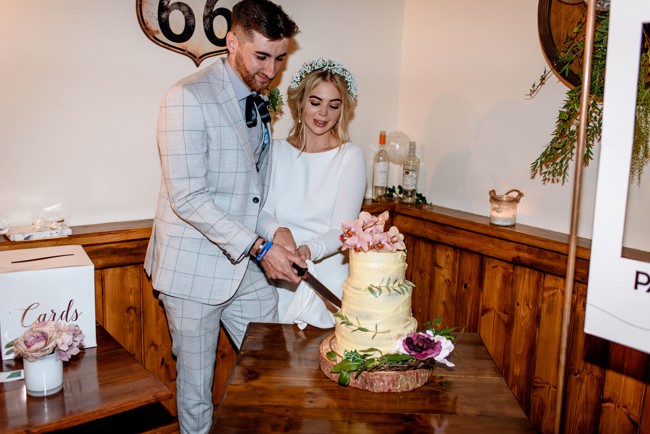 A wedding couple cutting a cake at Scrivelsby Walled Garden.