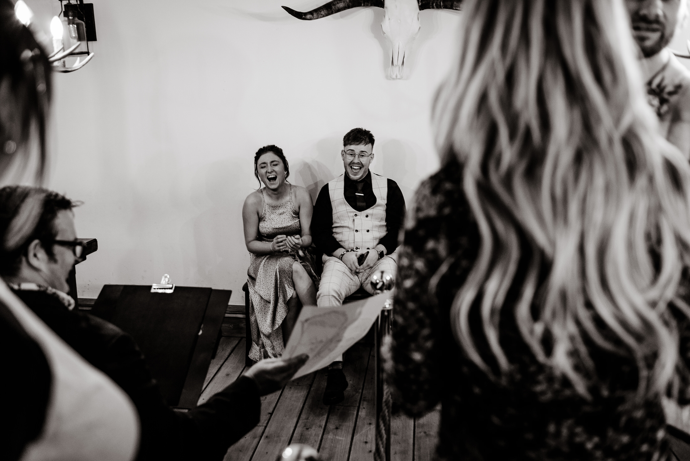 A breathtaking black and white photo capturing the essence of a wedding, featuring a bride and groom in an intimate room.