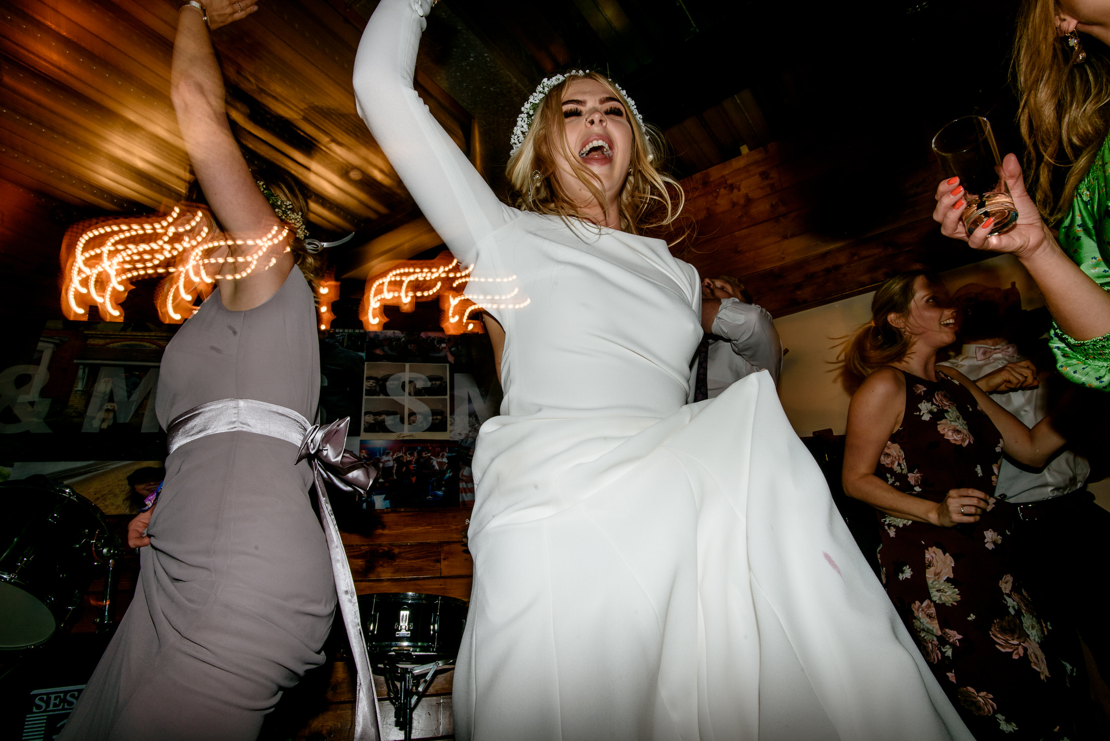 A bride is dancing on the dance floor at a wedding in Scrivelsby Walled Garden.